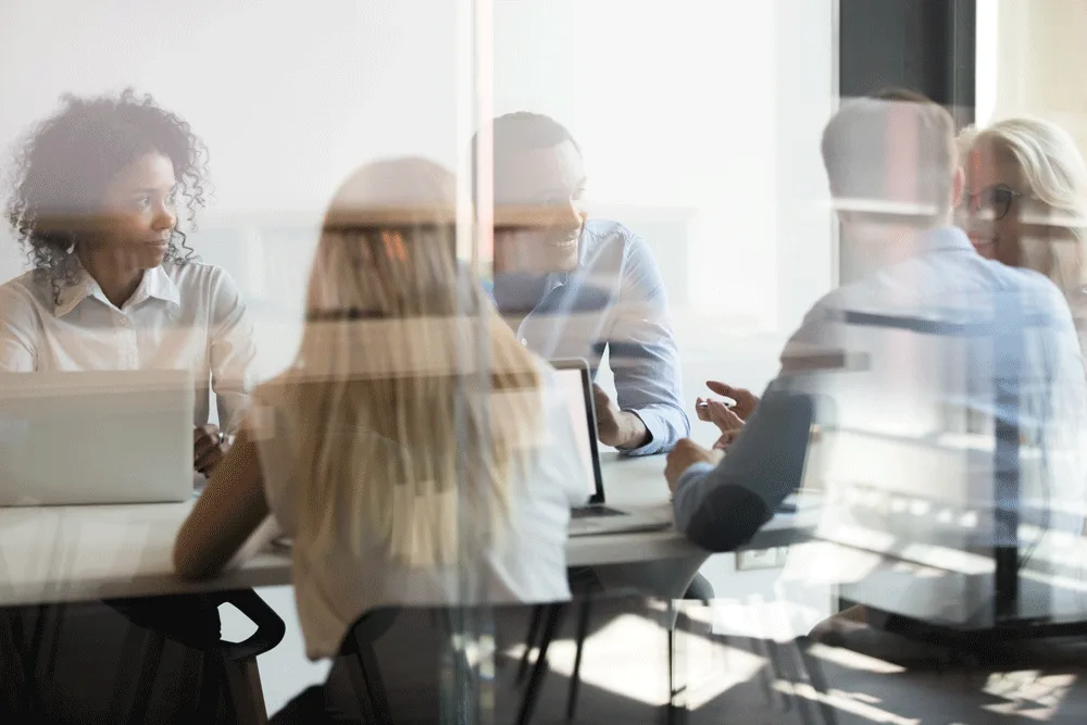 Colleagues talking around a meeting table